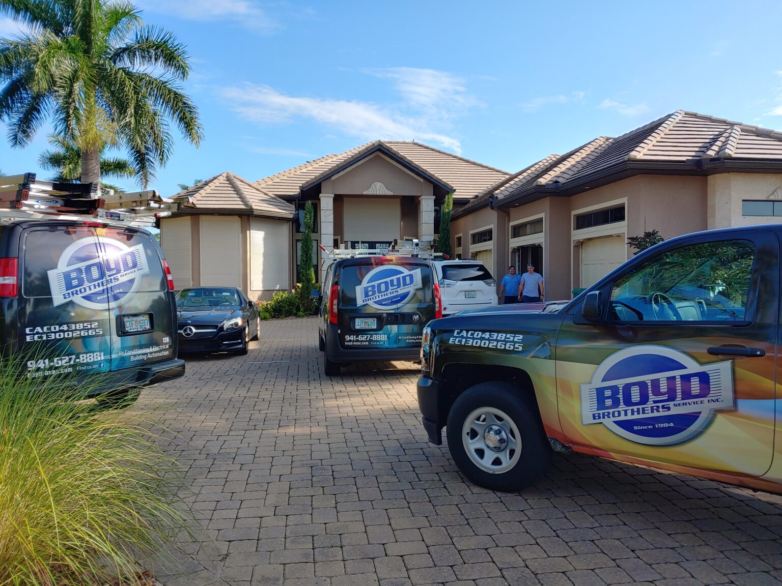 Three Boyd Brothers work trucks at a customer’s home in Southwest Florida