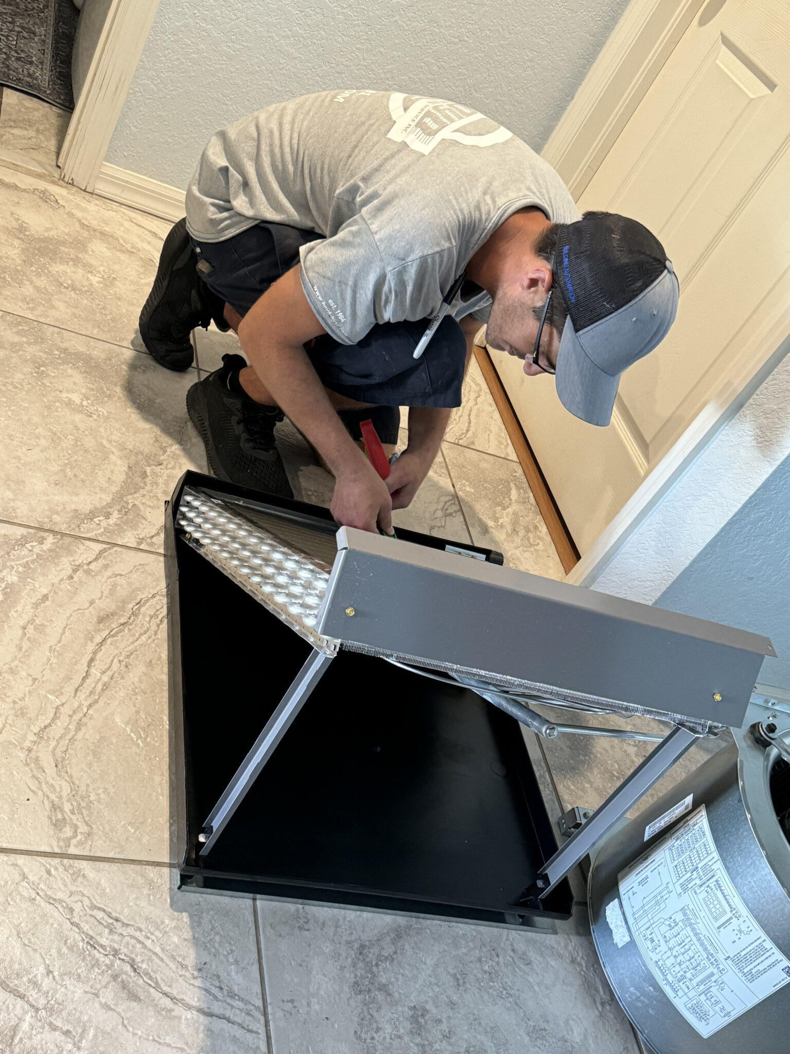 Boyd Brothers technician repairing an AC unit at a customer’s home in Southwest Florida