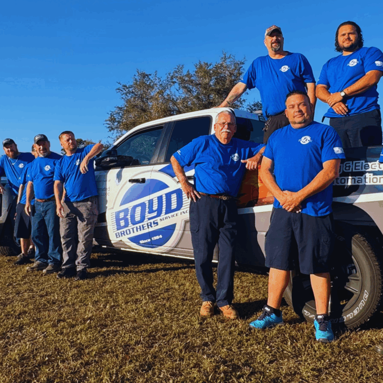 Boyd Brothers Service Inc. team posing together in front of a branded company van.