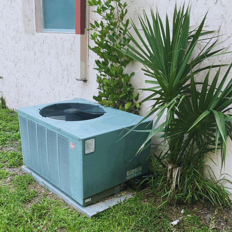 Large outdoor HVAC package unit installed on a concrete pad near a home with landscaping.